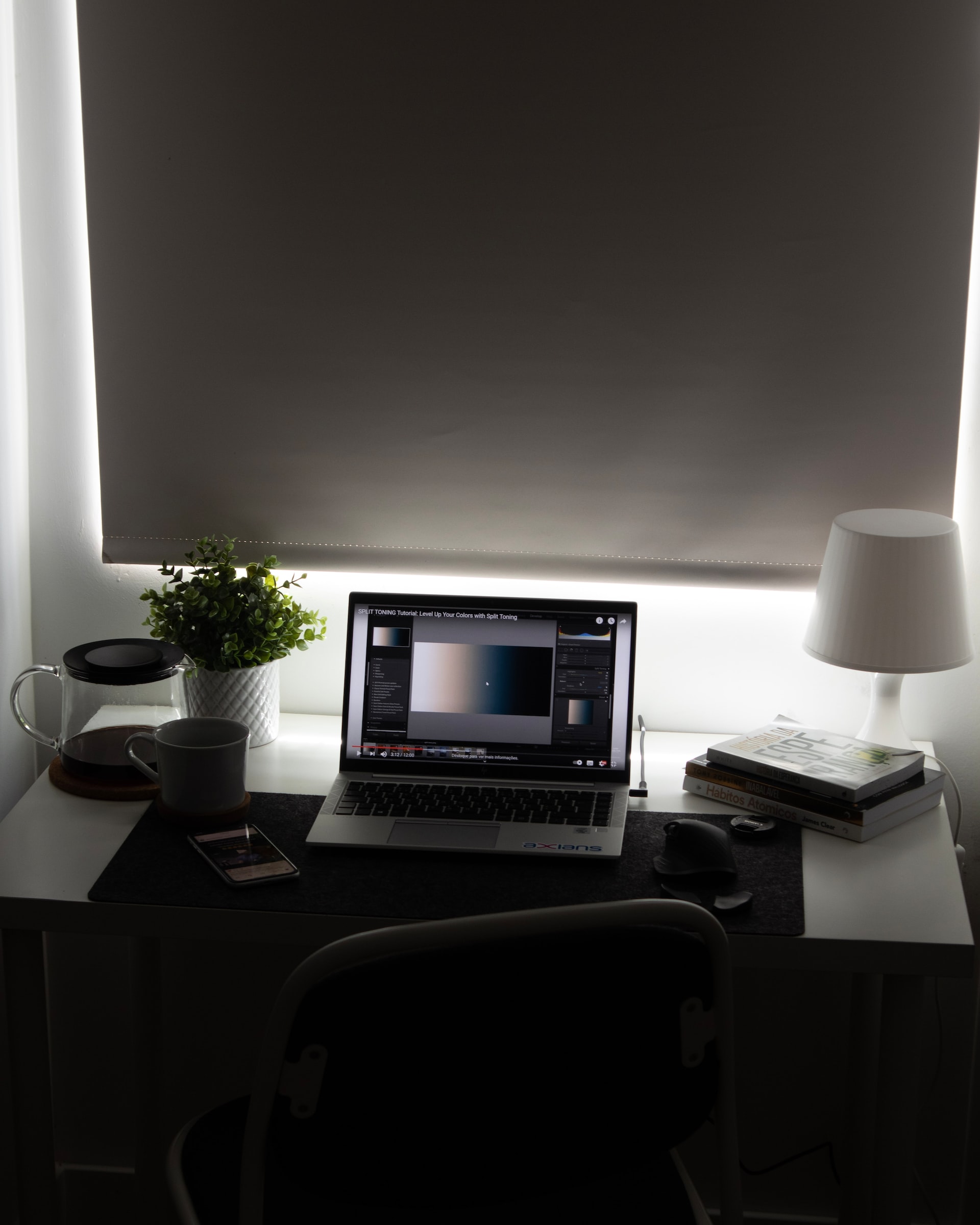 a laptop with adobe illustrator on its screen, on top of a desk